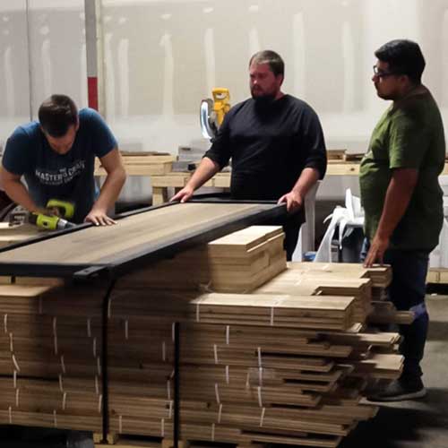 Employees build the prefinished barn doors.